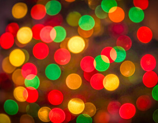 Red, green and gold bokeh lights creating a festive, abstract background, ideal for Christmas, holiday, celebration, or joyful themes.