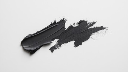 Black makeup smears forming dynamic graphic pattern intersecting across pristine white surface