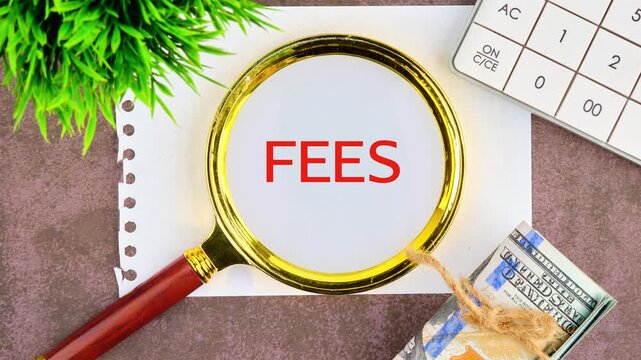 Business and finance concept. Animation of the FEES text through a magnifying glass on a piece of paper, top view