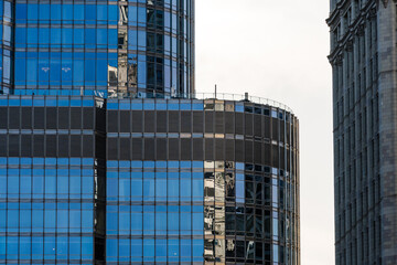 Modern skyscrapers in Chicago reflecting the sky on a cloudy day.