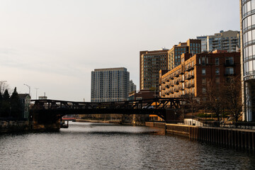 Chicago riverfront with bridges and tall buildings under a beautiful, slightly cloudy sky.