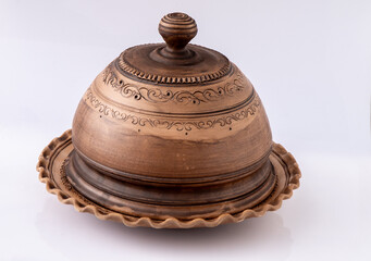 Brown Ceramic Plate with lid. Clay dish on white background. Handmade pot craft