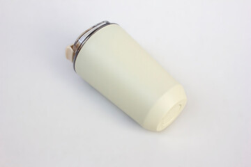 A sleek white stainless steel travel mug tumbler isolated on white, ready for your custom design, copy space, mockup design. This tumbler is used for keeping hot drinks like coffee or tea.