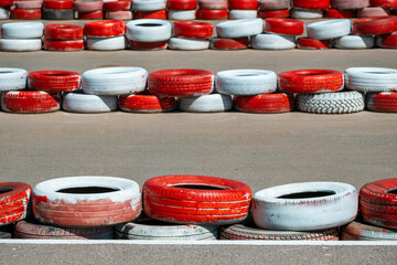 rows of tires on the highway to protect against drifts. secure fence on the go-kart track