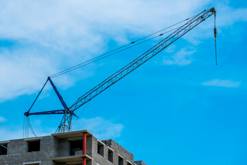 a crane near an apartment building under construction
