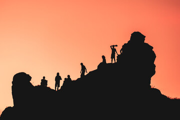 A group of people are standing on a mountain