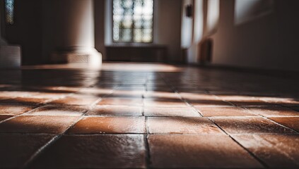 Sunlight casts warm shadows on a tiled floor inside a spacious, light-filled room.