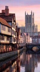 Fototapeta premium Serene riverside view of historic buildings at sunset, with a grand cathedral in the background