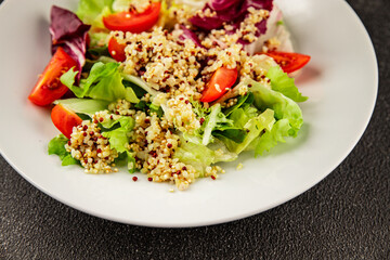 Quinoa salad tomato, green leaf salad vegetables dish natural tasty snack fresh delicious gourmet food background on the table rustic top view copy space keto and paleo diet vegan and vegan food