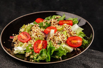 Quinoa salad tomato, green leaf salad vegetables dish natural tasty snack fresh delicious gourmet food background on the table rustic top view copy space keto and paleo diet vegan and vegan food