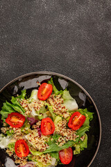Quinoa salad tomato, green leaf salad vegetables dish natural tasty snack fresh delicious gourmet food background on the table rustic top view copy space keto and paleo diet vegan and vegan food