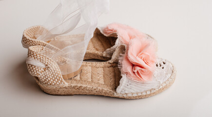 Elegant festive sandals with lace and pink bow.