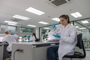 Students conduct experiments in a modern laboratory setting during a science class in the afternoon