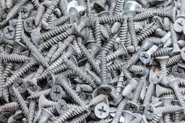 Pile of metal screws close up