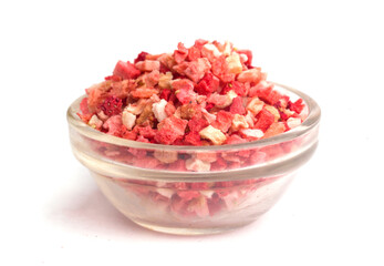 a bowl with dried strawberry pieces on a white background

