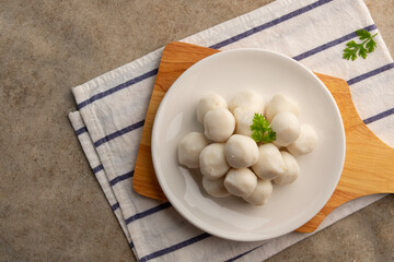 Uncooked Thai Pork meatballs on white plate.Top view with copy space.