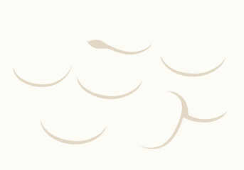 Obraz premium Seven tan curved shapes are scattered on a light background