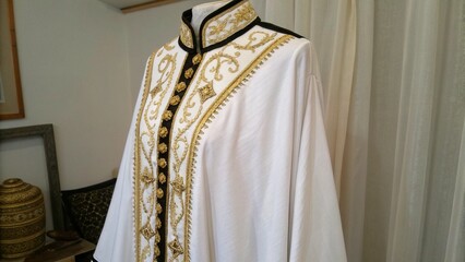 Elegant White and Gold Traditional Robe with Black Trim Details for Cultural Fashion Concept