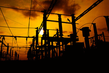 Silhouette of electrical substation against vibrant sunset sky in Bengaluru, India. Low angle...