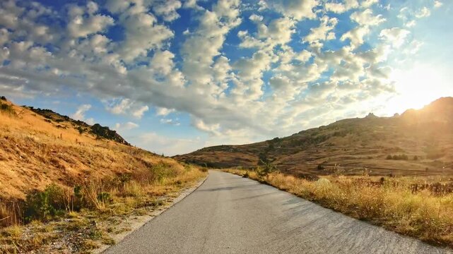 Highland scenery, golden meadows and gleaming sun, POV car trip