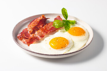 Delicious traditional English breakfast with fried eggs and bacon