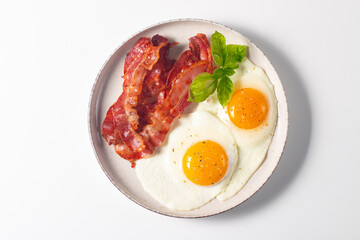 Delicious traditional English breakfast with fried eggs and bacon