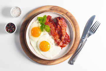 Delicious traditional English breakfast with fried eggs and bacon
