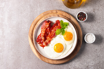 Delicious traditional English breakfast with fried eggs and bacon