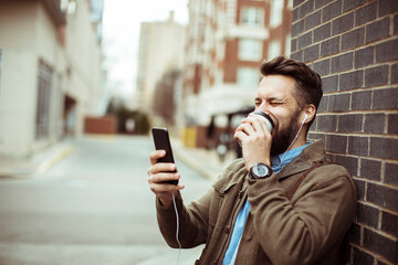 Man enjoying coffee and using smartphone
