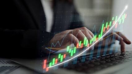 A business professional engages with data trends on a laptop, visualizing charts and graphs to analyze and forecast financial movements for strategic planning. Copula