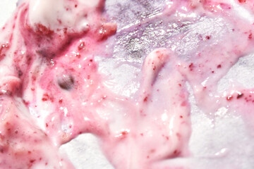 close up of swirled pink yogurt and berry mixture with visible berry seeds and creamy texture.