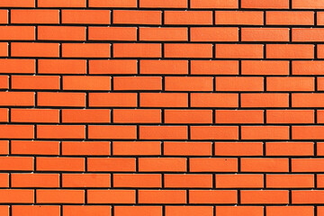 Obraz premium Orange brick wall abstract texture background. Rustic urban construction design. Strong masonry pattern for architecture. Exterior house wall with solid structure. Industrial vintage building.