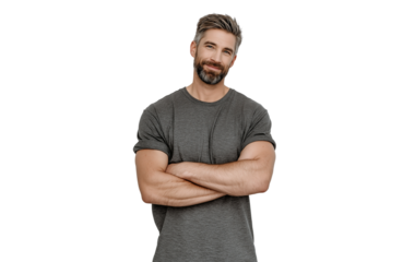 A man with a grey beard and short brown hair, wearing a grey tshirt, stands with his arms crossed and tilts his head slightly, isolated on transparent background