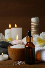 Herbal therapy, traditional medicine and homeopathy concept. Bath towel, candles and bottle natural organic oil essence. Set for spa, massage and aromatherapy 