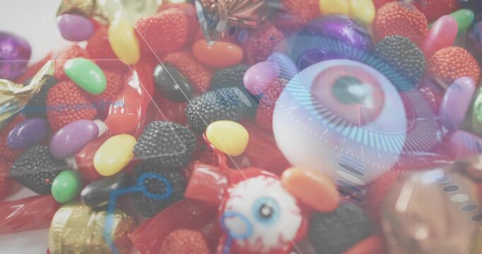 Assorted candies holding still until digital eyeball graphic fading pulsing revealing novelty candy