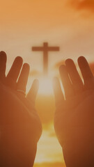  A person's hands are raised in a reverent gesture of prayer or worship, serving as the central focal point. The close-up, balanced composition emphasizes the detailed hands against a softly blurred b