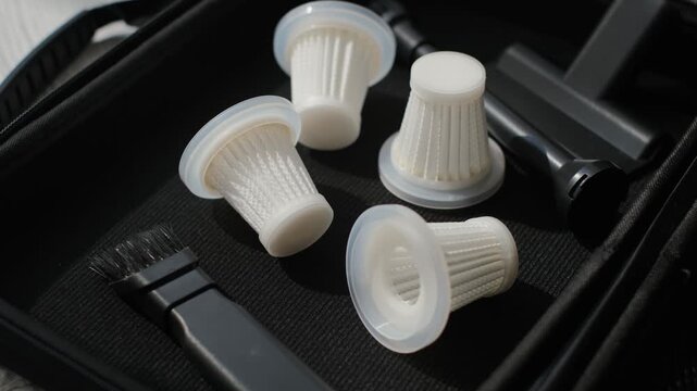 A close-up view of the filters of a compact portable car vacuum cleaner