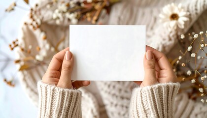 Hands holding blank card surrounded by autumnal decor