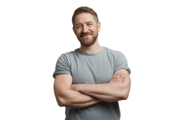 A smiling man with short brown hair and a beard, wearing a grey tshirt, standing with his arms crossed and looking at the camera, isolated on transparent background