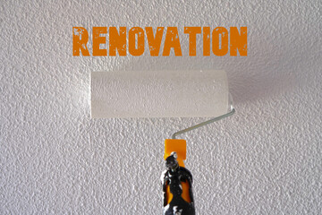 renovation concept. roller painting the wall white