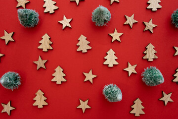Red Christmas background for a postcard: Santa Claus, fir tree, wooden stars, and pine trees
