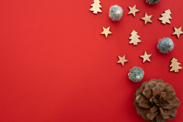 A red background with a bunch of Christmas decorations including stars and pine cones. The red background is the main focus of the image
