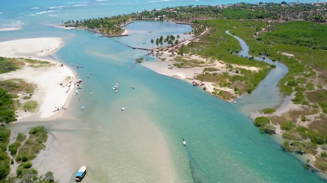 Aerial view of gunga beach with boats and turquoise water in brazil