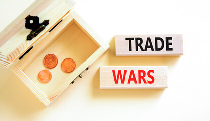 Trade wars symbol. Concept word Trade wars on beautiful wooden blocks. Beautiful white paper...