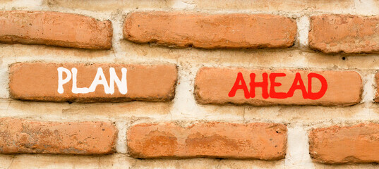 Fototapeta premium Plan ahead symbol. Concept word Plan ahead on beautiful old brown brick wall. Beautiful old brown brick wall background. Old brick wall. Business plan ahead concept. Copy space.