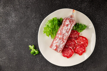 Dry sausage slice pork less fat jamon cured meat natural product tasty snack fresh delicious gourmet food background on the table rustic top view copy space