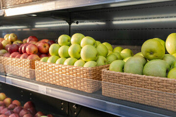 Boxes of apples in a supermarket, fruit sales.