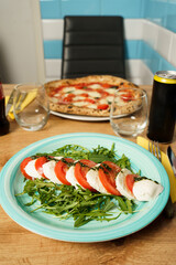 Caprese salad with arugula served in Italian restaurant