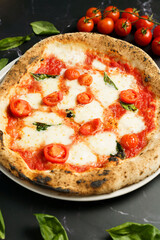 Neapolitan pizza with fresh cherry tomatoes and basil