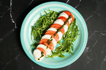 Caprese salad with mozzarella and arugula